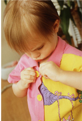 Girl buttoning her shirt